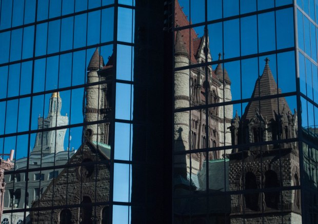 On Sunday September 29, the Trinity Church reflects off the John Hancock building in Copley Square. Created by Chelsea Diana.